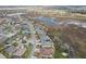 A neighborhood aerial view highlights lush landscaping, water features, and beautiful community design at 960 Pickering Path, The Villages, FL 32163