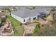 An aerial shot shows a backyard with a stone pathway and patio area amongst a nicely landscaped yard at 960 Pickering Path, The Villages, FL 32163