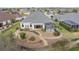 Aerial view of a backyard featuring landscaping, a stone pathway, and a screened-in lanai at 960 Pickering Path, The Villages, FL 32163