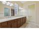 Bright bathroom featuring a double sink vanity and a glass block window for natural light at 960 Pickering Path, The Villages, FL 32163