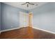 Bedroom featuring hardwood floors, closet with double doors, and a ceiling fan at 960 Pickering Path, The Villages, FL 32163