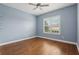 Bedroom with hardwood floors, a ceiling fan, and a window with plantation shutters at 960 Pickering Path, The Villages, FL 32163