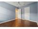 Bedroom featuring hardwood floors, closet with double doors, and a ceiling fan at 960 Pickering Path, The Villages, FL 32163