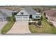 A well-maintained home with a two-car garage, green lawn, and beautifully landscaped front yard at 960 Pickering Path, The Villages, FL 32163