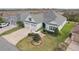 Beautiful home with a well-manicured lawn, landscaping, and a spacious driveway leading to a two-car garage at 960 Pickering Path, The Villages, FL 32163
