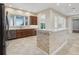 Updated kitchen with stone-clad breakfast bar, stainless appliances, and ample counter space at 960 Pickering Path, The Villages, FL 32163