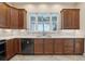Kitchen features wooden cabinets, stainless steel appliances, tile backsplash, undermount lighting and large window at 960 Pickering Path, The Villages, FL 32163