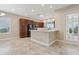 Well-lit kitchen featuring granite countertops, stainless steel appliances, and a stone-clad breakfast bar at 960 Pickering Path, The Villages, FL 32163