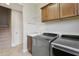 Laundry room with modern washer and dryer, cabinetry, and a sink at 960 Pickering Path, The Villages, FL 32163