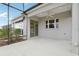 Covered back patio with ceiling fan, a sliding glass door and a large window for plenty of light at 960 Pickering Path, The Villages, FL 32163