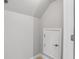 Hallway with an access door to storage; the floor is tan at 960 Pickering Path, The Villages, FL 32163