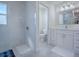 Modern bathroom featuring a walk-in shower, vanity with sink, and tiled floors at 998 Sayle St, The Villages, FL 32162