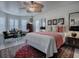 Bright bedroom with a ceiling fan, bay window, and comfortable furnishings, including a decorative rug at 998 Sayle St, The Villages, FL 32162