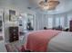 Spacious bedroom with a ceiling fan and sliding mirror door offers ample closet space at 998 Sayle St, The Villages, FL 32162