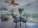 Bright dining area with a glass table, modern chairs, and a view of the outdoors at 998 Sayle St, The Villages, FL 32162