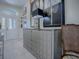 Entryway featuring modern cabinet storage, decor, and chair with view to front door at 998 Sayle St, The Villages, FL 32162