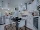 Bright kitchen boasts white cabinetry, stainless steel appliances, and modern finishes at 998 Sayle St, The Villages, FL 32162
