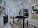 Kitchen with stainless steel appliances, white cabinetry, and eat-in space at 998 Sayle St, The Villages, FL 32162