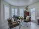 Cozy living room featuring comfortable seating, natural light, and a tranquil setting at 998 Sayle St, The Villages, FL 32162