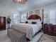 Inviting main bedroom features a four-poster bed, neutral tones, and comfortable furnishings at 998 Sayle St, The Villages, FL 32162