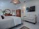 Serene main bedroom with a sitting area, a mounted television, and soothing decor at 998 Sayle St, The Villages, FL 32162