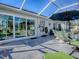 The screened in patio features stylish outdoor furniture and a relaxing atmosphere at 998 Sayle St, The Villages, FL 32162