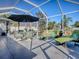 Enjoy the outdoors in this screened-in patio with comfortable lounge chairs and dining area at 998 Sayle St, The Villages, FL 32162