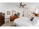 Bedroom featuring a dresser, television, and a view of the ensuite bathroom at 10105 Ketch Kay Ln, Oxford, FL 34484