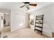 Bright bedroom with neutral carpet, large closet, ladder shelf, and natural light from the window with decor curtains at 10105 Ketch Kay Ln, Oxford, FL 34484