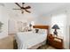 Bedroom with a large bed, ceiling fan, and view of the ensuite bathroom at 10105 Ketch Kay Ln, Oxford, FL 34484