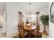 Bright dining room with a wooden table set and charming chandelier lighting at 10105 Ketch Kay Ln, Oxford, FL 34484