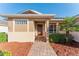 Inviting front entrance with a brick pathway, well-maintained landscaping, and a stylish front door at 10105 Ketch Kay Ln, Oxford, FL 34484