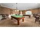 Spacious game room featuring two billiard tables, elegant lighting, and classic decor at 10105 Ketch Kay Ln, Oxford, FL 34484