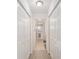 Hallway lined with closet doors, leading to the bathroom and other rooms at 10105 Ketch Kay Ln, Oxford, FL 34484