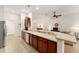 Open kitchen featuring an island with bar seating and stainless steel appliances at 10105 Ketch Kay Ln, Oxford, FL 34484