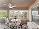 Bright sunroom with neutral decor, ceiling fan, large windows and natural light at 10105 Ketch Kay Ln, Oxford, FL 34484