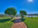 Picturesque walking path leading to a serene lake view, perfect for relaxing strolls at 10105 Ketch Kay Ln, Oxford, FL 34484