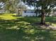 Exterior shot of home with a lush lawn and mature tree providing ample shade at 10301 Us Highway 27 # 39, Clermont, FL 34711