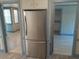 Stainless steel refrigerator with views into the adjacent bedrooms at 10301 Us Highway 27 # 39, Clermont, FL 34711