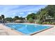 Large community pool with lounge chairs, umbrellas, and beautiful mature trees at 10301 Us Highway 27 # 39, Clermont, FL 34711