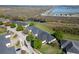 Aerial view of the home with community waterfront, boat dock and landscaping at 1037 Green Gate Blvd, Groveland, FL 34736