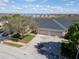 Aerial view of the home with three-car garage and a pristine lawn at 1037 Green Gate Blvd, Groveland, FL 34736