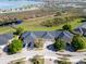 Aerial view of the home with three-car garage, community waterfront and landscaping at 1037 Green Gate Blvd, Groveland, FL 34736