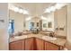 Bright bathroom featuring granite countertops, double sinks, and ample lighting at 1037 Green Gate Blvd, Groveland, FL 34736