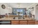 Open kitchen view showing living area beyond, granite countertops, and modern fixtures at 1037 Green Gate Blvd, Groveland, FL 34736