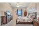 Well-lit main bedroom featuring a carpet flooring, a ceiling fan and a wooden bed frame at 1037 Green Gate Blvd, Groveland, FL 34736