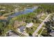 Overhead view of a home near a serene lake, surrounded by lush greenery and neighboring houses at 1041 Eastbrook Ave, Deltona, FL 32738