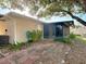 View of the patio and screened in sunroom from the backyard of the home at 1041 Eastbrook Ave, Deltona, FL 32738