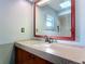 Bathroom vanity featuring a large framed mirror and a granite countertop at 1041 Eastbrook Ave, Deltona, FL 32738