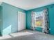 Inviting bedroom with closet, a sunlit window, and soothing blue walls at 1041 Eastbrook Ave, Deltona, FL 32738